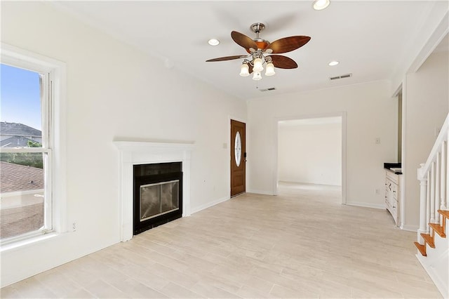 unfurnished living room featuring light wood-type flooring and ceiling fan