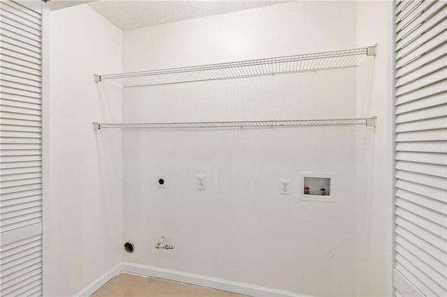 washroom with hookup for an electric dryer, washer hookup, and a textured ceiling