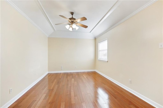 spare room featuring crown molding, ceiling fan, and light wood-type flooring