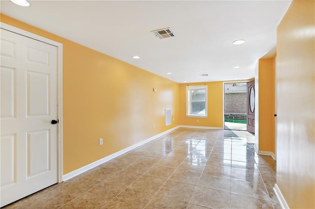 unfurnished room with light tile patterned floors