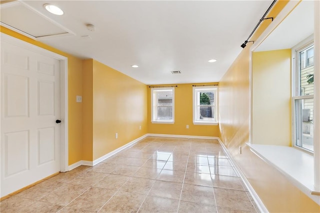 tiled spare room with a wealth of natural light