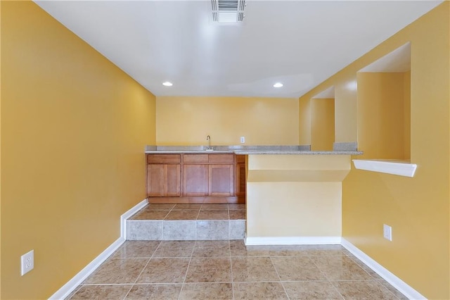 bar with sink and light tile patterned flooring