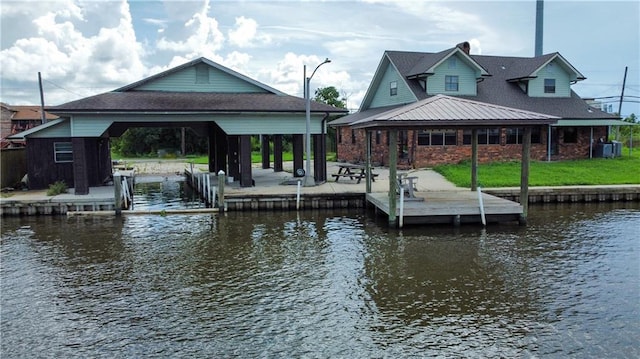 dock area with a gazebo and a water view