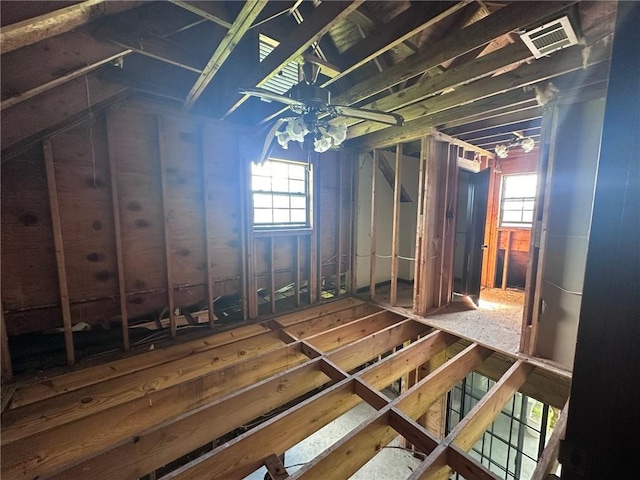 unfinished attic featuring a healthy amount of sunlight