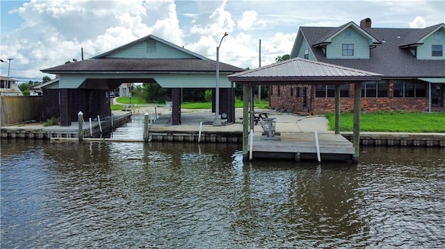 view of dock with a gazebo and a water view