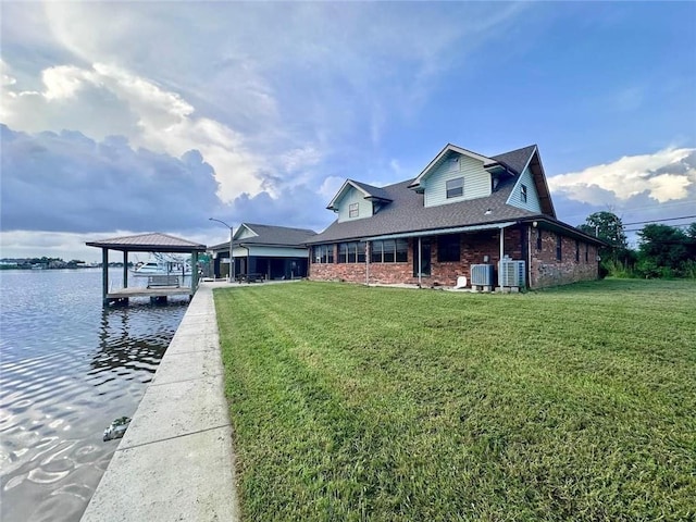 dock area featuring a lawn, central AC, and a water view