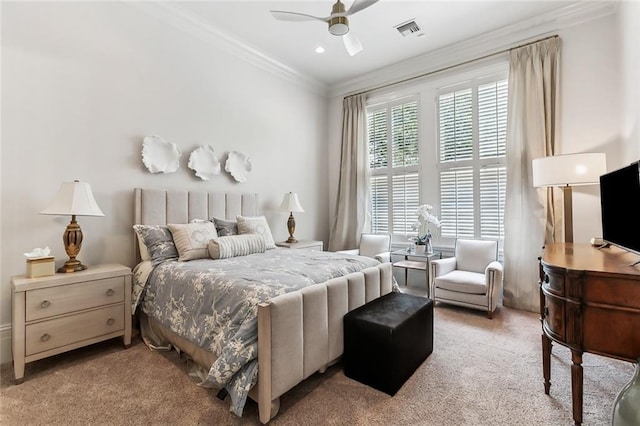 bedroom with ceiling fan, crown molding, and light carpet