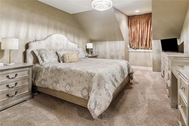 bedroom featuring a chandelier, light colored carpet, and vaulted ceiling