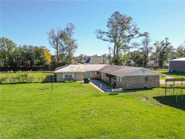 rear view of property featuring a lawn