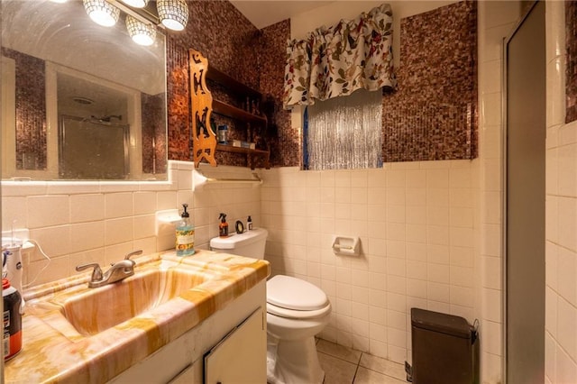 bathroom with an enclosed shower, tile walls, and toilet