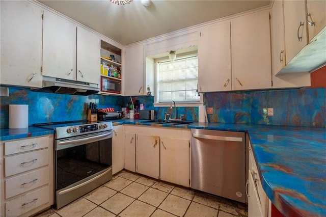 kitchen with backsplash, sink, white cabinets, and stainless steel appliances