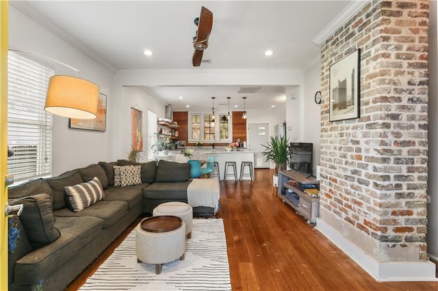 living room with dark hardwood / wood-style floors and ornamental molding