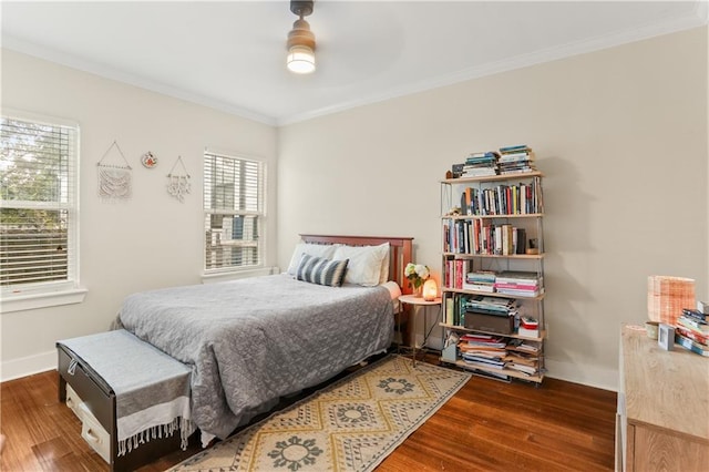 bedroom featuring ceiling fan, wood-type flooring, and ornamental molding