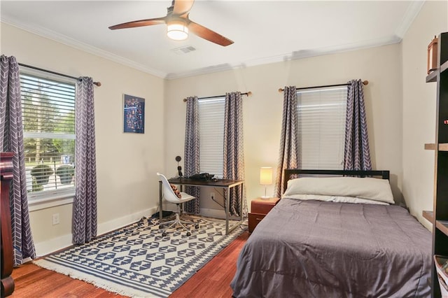 bedroom with multiple windows, ceiling fan, and hardwood / wood-style flooring