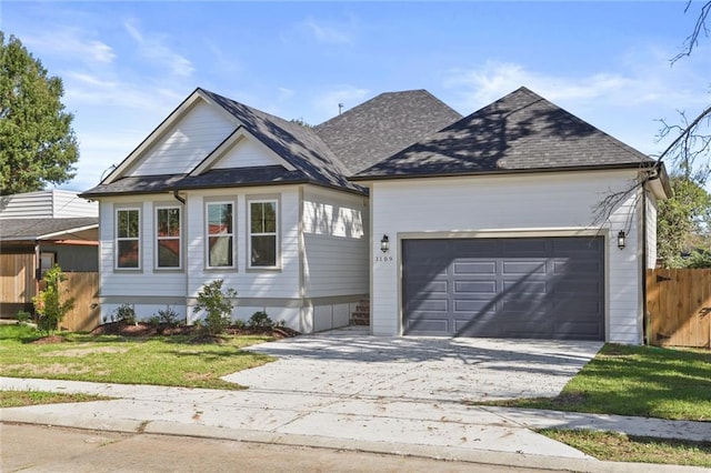 view of front of property with a garage and a front yard