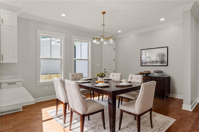 dining space with ornamental molding, dark hardwood / wood-style flooring, and a healthy amount of sunlight