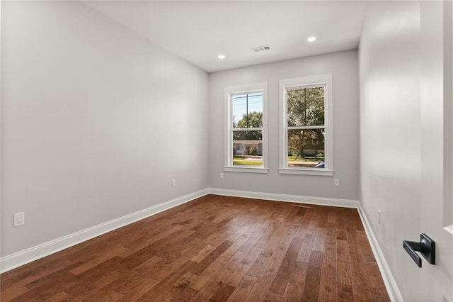 unfurnished room featuring dark wood-type flooring