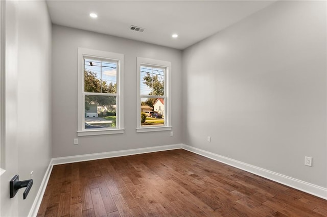 spare room with dark wood-type flooring