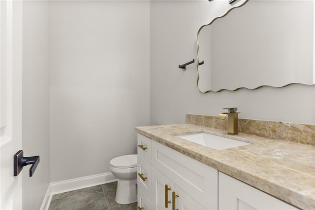 bathroom featuring tile patterned flooring, vanity, and toilet