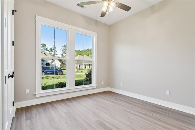 empty room with ceiling fan and light hardwood / wood-style floors