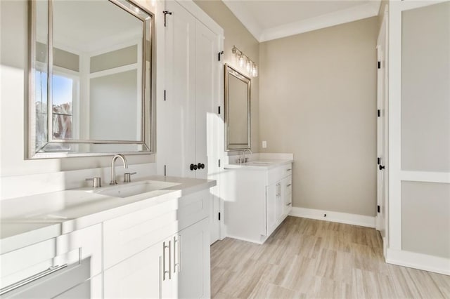 bathroom with wood-type flooring, vanity, and crown molding