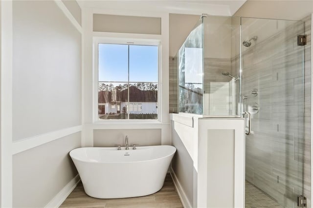 bathroom featuring wood-type flooring and independent shower and bath