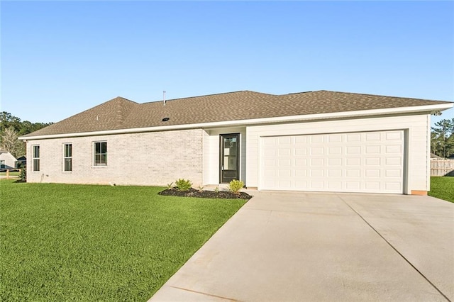 view of front of house featuring a garage and a front lawn