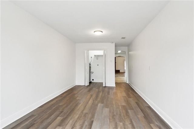 unfurnished room featuring dark wood-type flooring