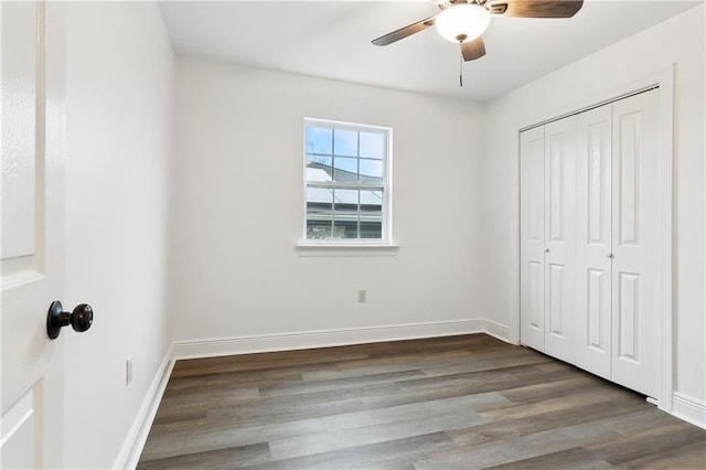 unfurnished bedroom featuring wood-type flooring, ceiling fan, and a closet