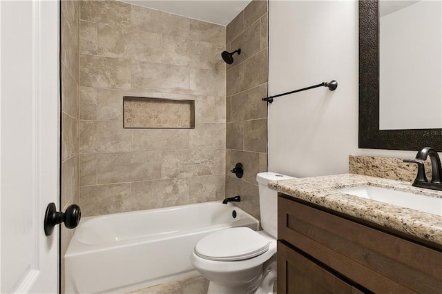 full bathroom with vanity, tiled shower / bath combo, and toilet