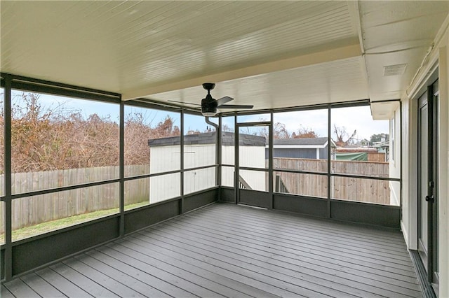 unfurnished sunroom featuring ceiling fan