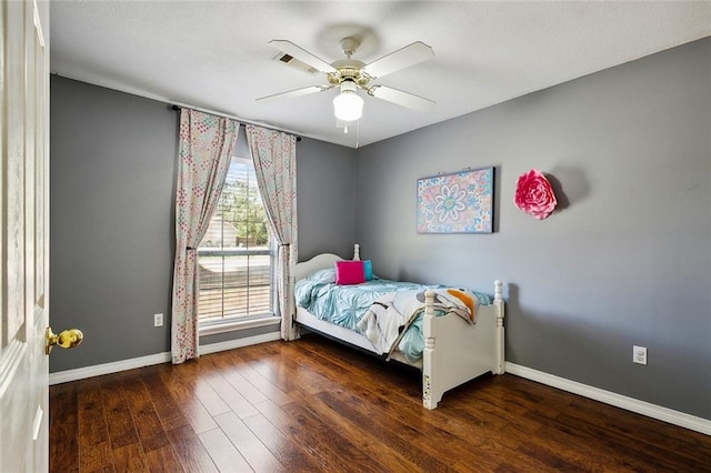 bedroom featuring dark hardwood / wood-style flooring and ceiling fan