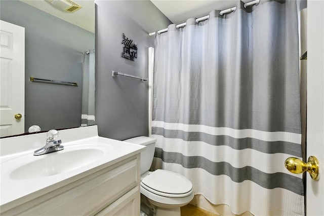 bathroom featuring walk in shower, vanity, and toilet