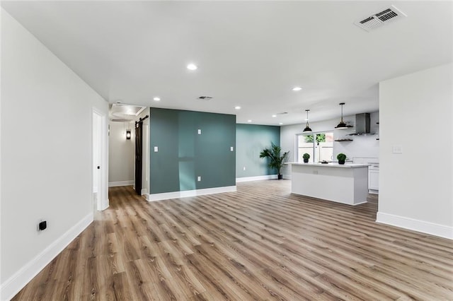 7470 Briarheath Dr, New Orleans, LA 70128 - unfurnished living room featuring light wood-style flooring, recessed lighting, and baseboards