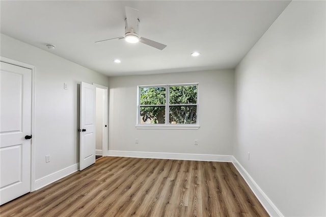 unfurnished bedroom with hardwood / wood-style floors and ceiling fan