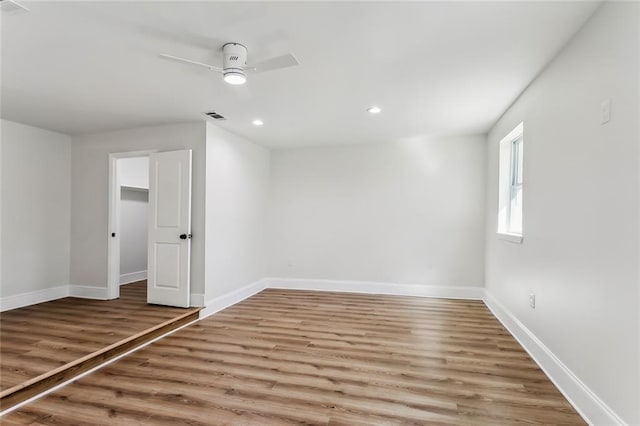 empty room with wood-type flooring and ceiling fan