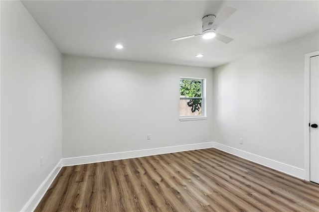 spare room with wood-type flooring and ceiling fan