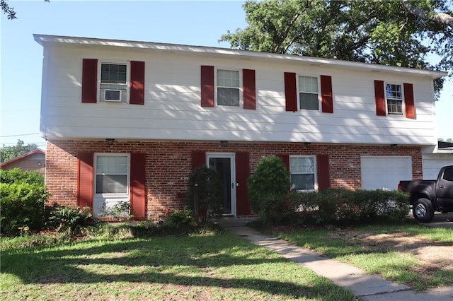 view of front of house with a garage, a front lawn, and cooling unit