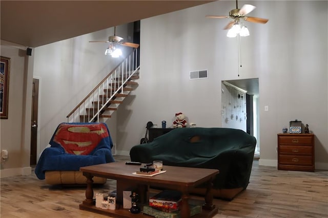 living room with ceiling fan and light wood-type flooring