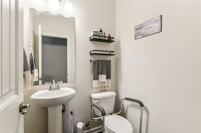 bathroom featuring toilet and sink