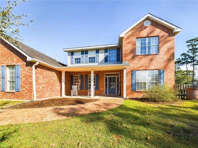 1024 Claire Dr, Slidell, LA 70461 - traditional-style home featuring a porch, brick siding, and a front lawn
