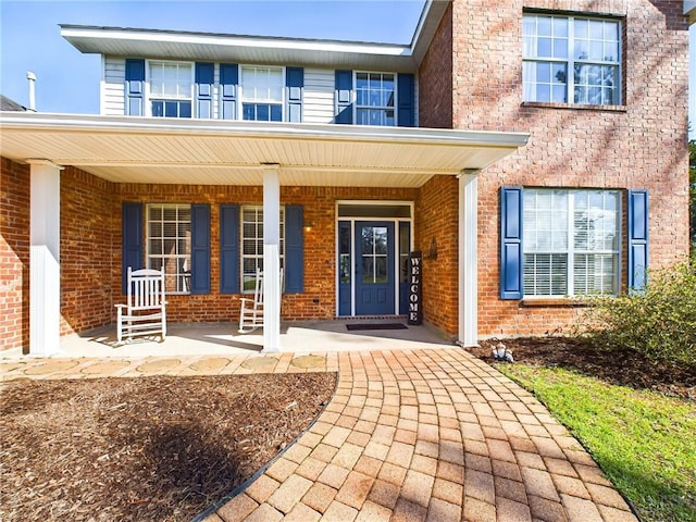 1024 Claire Dr, Slidell, LA 70461 - view of exterior entry with brick siding and a porch