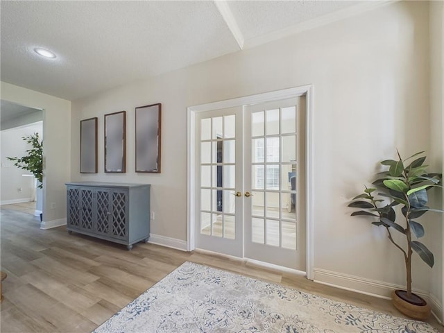 1024 Claire Dr, Slidell, LA 70461 - entryway featuring a textured ceiling, light wood finished floors, and french doors