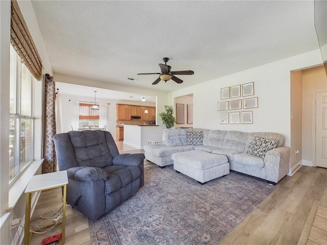 living room featuring hardwood / wood-style floors and ceiling fan