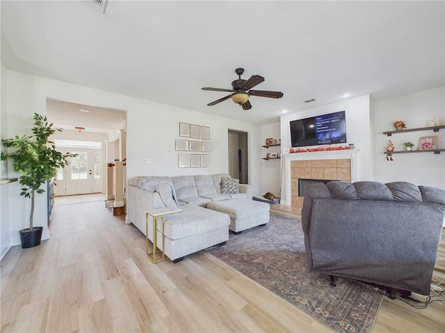 1024 Claire Dr, Slidell, LA 70461 - living area featuring a tile fireplace, light wood-type flooring, ceiling fan, and recessed lighting