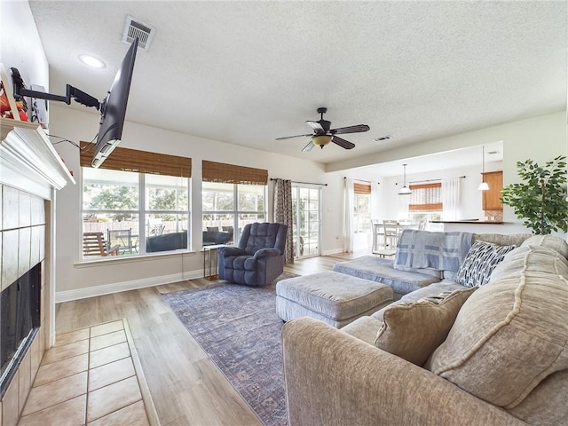 1024 Claire Dr, Slidell, LA 70461 - living area featuring a textured ceiling, ceiling fan, light wood-style flooring, and recessed lighting