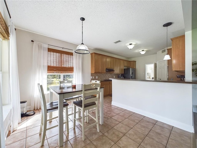 1024 Claire Dr, Slidell, LA 70461 - dining area with a textured ceiling and light tile patterned floors