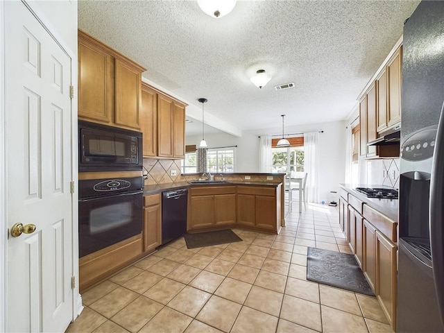1024 Claire Dr, Slidell, LA 70461 - kitchen featuring black appliances, a peninsula, under cabinet range hood, decorative backsplash, and light tile patterned floors
