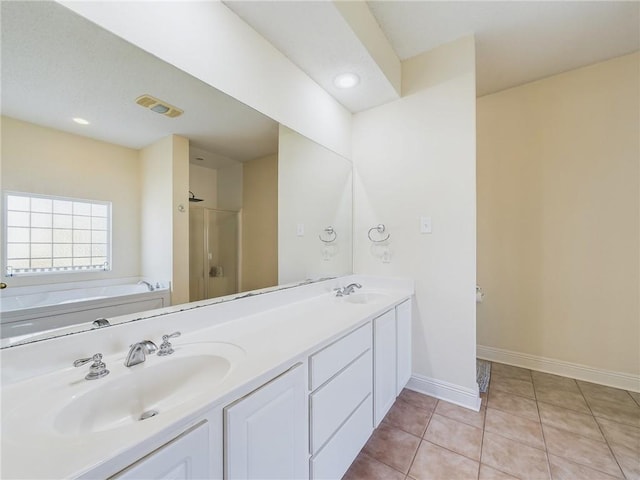 bathroom featuring plus walk in shower, tile patterned flooring, and vanity