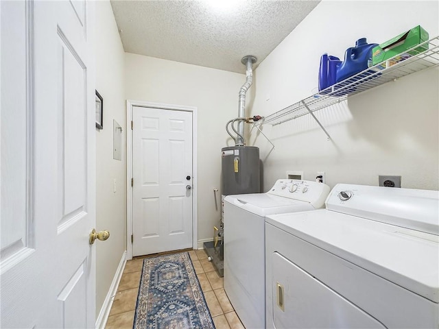1024 Claire Dr, Slidell, LA 70461 - laundry area with washing machine and clothes dryer, a textured ceiling, light tile patterned floors, and water heater
